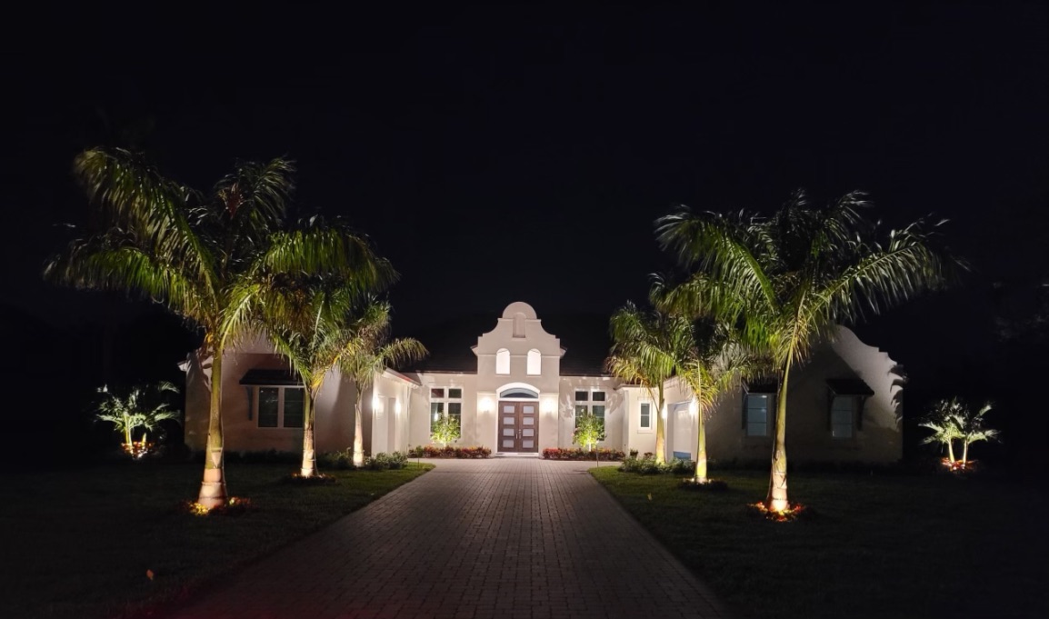 Beautiful home with professional landscape lighting at night